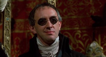 Movie still from “The Adventures of Baron Munchausen” (1988), directed by Terry Gilliam – A man wearing a black jacket and sunglasses; Close Up shot, Low angle