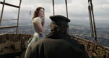 Movie still from “The Aeronauts” (2019), directed by Tom Harper – A man and a woman are standing on a bridge; Medium shot, Low angle