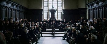 Movie still from “The Aeronauts” (2019), directed by Tom Harper – A group of people sitting in front of a large window; Wide shot, High angle