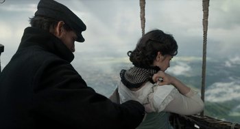 Movie still from “The Aeronauts” (2019), directed by Tom Harper – A man helping a young girl with her hair; Medium shot, Over the shoulder angle