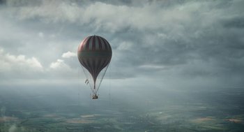Movie still from “The Aeronauts” (2019), directed by Tom Harper – A hot air balloon is flying in the sky; Extreme Wide shot, Low angle