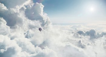 Movie still from “The Aeronauts” (2019), directed by Tom Harper – A hot air balloon is flying through the clouds; Extreme Wide shot, Low angle