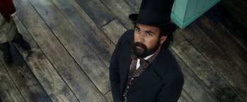 Movie still from “The Aeronauts” (2019), directed by Tom Harper – A man wearing a top hat and a suit; Close Up shot, Overhead angle