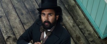 Movie still from “The Aeronauts” (2019), directed by Tom Harper – A man with a beard wearing a top hat; Close Up shot, Low angle