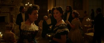 Movie still from “The Aeronauts” (2019), directed by Tom Harper – Two women in old - fashioned dresses standing next to each other; Medium shot, Over the shoulder angle