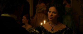 Movie still from “The Aeronauts” (2019), directed by Tom Harper – A woman in a black dress holding a lit candle; Close Up shot, Over the shoulder angle