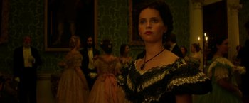 Movie still from “The Aeronauts” (2019), directed by Tom Harper – A woman standing in front of a group of people; Close Up shot, Low angle