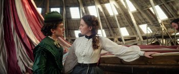 Movie still from “The Aeronauts” (2019), directed by Tom Harper – Two women dressed in period clothing in an old barn; Medium shot, Low angle