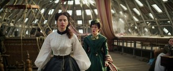 Movie still from “The Aeronauts” (2019), directed by Tom Harper – Two women dressed in period clothing walk together; Medium shot, Low angle