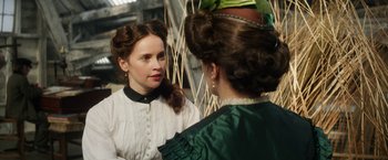 Movie still from “The Aeronauts” (2019), directed by Tom Harper – Two women are talking to each other in front of a wall; Close Up shot, Over the shoulder angle