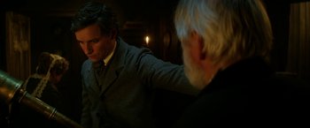 Movie still from “The Aeronauts” (2019), directed by Tom Harper – A man in a suit and a man in a tie; Medium shot, Over the shoulder angle