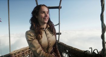 Movie still from “The Aeronauts” (2019), directed by Tom Harper – A woman sitting in a basket on top of a hill; Close Up shot, Low angle