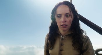 Movie still from “The Aeronauts” (2019), directed by Tom Harper – A woman with long brown hair is standing in front of the sky; Close Up shot, Low angle