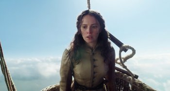 Movie still from “The Aeronauts” (2019), directed by Tom Harper – A woman with long brown hair standing on top of a boat; Close Up shot, Low angle
