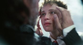 Movie still from “The Aeronauts” (2019), directed by Tom Harper – A young woman looking into a mirror while wearing a red tie; Extreme Close Up shot, Over the shoulder angle