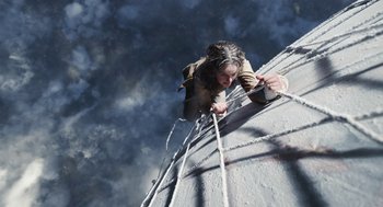 Movie still from “The Aeronauts” (2019), directed by Tom Harper – A woman climbing up the side of a building; Wide shot, Overhead angle