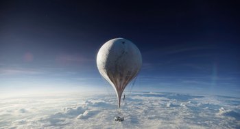 Movie still from “The Aeronauts” (2019), directed by Tom Harper – A white hot air balloon floating in the sky above the clouds; Extreme Wide shot, Low angle