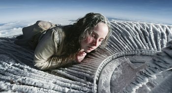 Movie still from “The Aeronauts” (2019), directed by Tom Harper – A woman laying on top of an object; Medium shot, Overhead angle