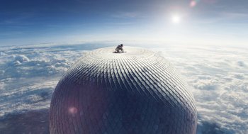 Movie still from “The Aeronauts” (2019), directed by Tom Harper – A person sitting on top of a ball in the sky; Extreme Wide shot, Overhead angle