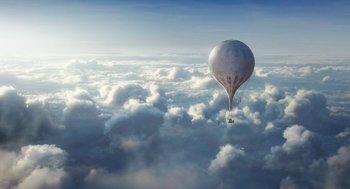 Movie still from “The Aeronauts” (2019), directed by Tom Harper – A hot air balloon is flying through the sky; Extreme Wide shot, Low angle