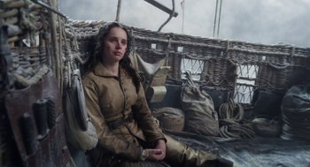 Movie still from “The Aeronauts” (2019), directed by Tom Harper – A woman sitting on top of a boat in the water; Medium shot, High angle