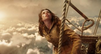 Movie still from “The Aeronauts” (2019), directed by Tom Harper – A woman standing on top of a boat in the sky; Medium shot, Low angle