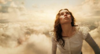 Movie still from “The Aeronauts” (2019), directed by Tom Harper – A woman in a white shirt looking up at the sky; Medium shot, Low angle