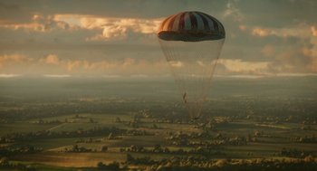Movie still from “The Aeronauts” (2019), directed by Tom Harper – A parachute is flying over a large field; Extreme Wide shot, High angle