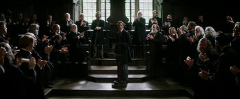 Movie still from “The Aeronauts” (2019), directed by Tom Harper – A group of people standing in front of an audience; Wide shot, Low angle