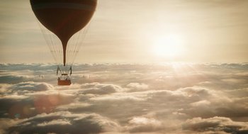 Movie still from “The Aeronauts” (2019), directed by Tom Harper – A hot - air balloon flying over the clouds at sunset; Extreme Wide shot, Low angle
