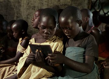 Movie still from “The African Queen” (1951), directed by John Huston – A group of young boys sitting next to each other; Medium shot, High angle