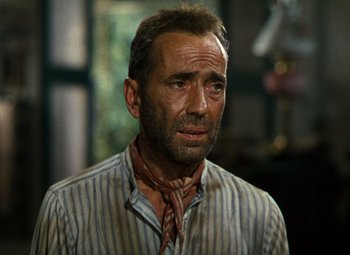 Movie still from “The African Queen” (1951), directed by John Huston – A person wearing a neck tie; Close Up shot, Low angle