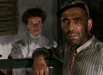 Movie still from “The African Queen” (1951), directed by John Huston – A man and a woman standing next to each other; Close Up shot, Low angle