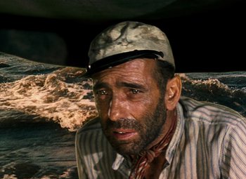Movie still from “The African Queen” (1951), directed by John Huston – A person wearing a hat; Close Up shot, High angle