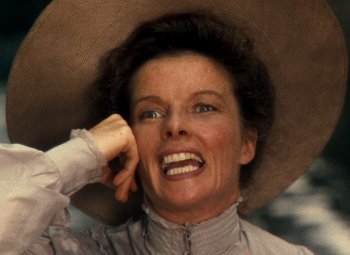 Movie still from “The African Queen” (1951), directed by John Huston – An older woman wearing a hat and holding a cell phone to her ear; Close Up shot, Low angle