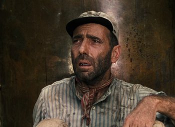 Movie still from “The African Queen” (1951), directed by John Huston – A person wearing a hat; Close Up shot, Low angle