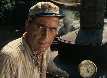 Movie still from “The African Queen” (1951), directed by John Huston – An old man wearing a hat is looking at the camera; Close Up shot, Low angle
