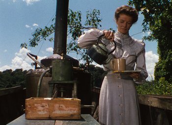 Movie still from “The African Queen” (1951), directed by John Huston – A woman pouring tea into a tea pot; Medium shot, Low angle
