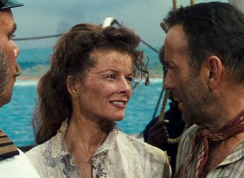 Movie still from “The African Queen” (1951), directed by John Huston – A man and a woman on a boat in the water; Close Up shot, Low angle