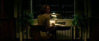 Movie still from “The Age of Adaline” (2015), directed by Lee Toland Krieger – A woman sitting at a table with a book in front of her; Medium shot, Over the shoulder angle