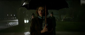 Movie still from “The Age of Adaline” (2015), directed by Lee Toland Krieger – A woman holding an umbrella in the rain; Medium shot, Low angle