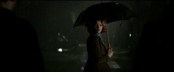 Movie still from “The Age of Adaline” (2015), directed by Lee Toland Krieger – A woman holding an umbrella in the rain; Medium shot, Low angle