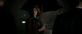 Movie still from “The Age of Adaline” (2015), directed by Lee Toland Krieger – A woman holding an umbrella in the rain; Medium shot, Low angle