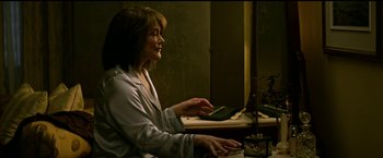 Movie still from “The Age of Adaline” (2015), directed by Lee Toland Krieger – A woman sitting in front of a computer keyboard; Medium shot, Over the shoulder angle