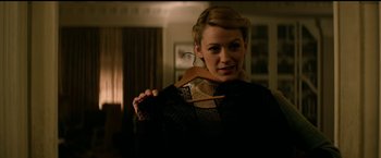 Movie still from “The Age of Adaline” (2015), directed by Lee Toland Krieger – A woman is holding an item in her hand; Medium shot, Over the shoulder angle