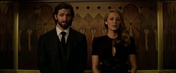 Movie still from “The Age of Adaline” (2015), directed by Lee Toland Krieger – A man and a woman standing next to each other in front of a wall; Medium shot, Low angle