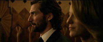 Movie still from “The Age of Adaline” (2015), directed by Lee Toland Krieger – A man in a suit and a woman in a black suit; Close Up shot, Over the shoulder angle