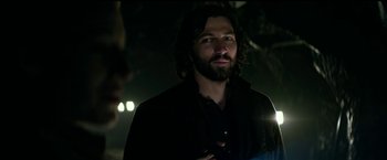 Movie still from “The Age of Adaline” (2015), directed by Lee Toland Krieger – A man with long hair and a beard standing in the dark; Close Up shot, Over the shoulder angle