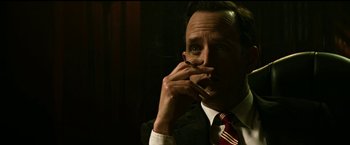 Movie still from “The Age of Adaline” (2015), directed by Lee Toland Krieger – A man in a suit and tie smoking a cigarette; Close Up shot, Low angle