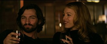 Movie still from “The Age of Adaline” (2015), directed by Lee Toland Krieger – A man and a woman are smiling and holding wine glasses; Close Up shot, Over the shoulder angle